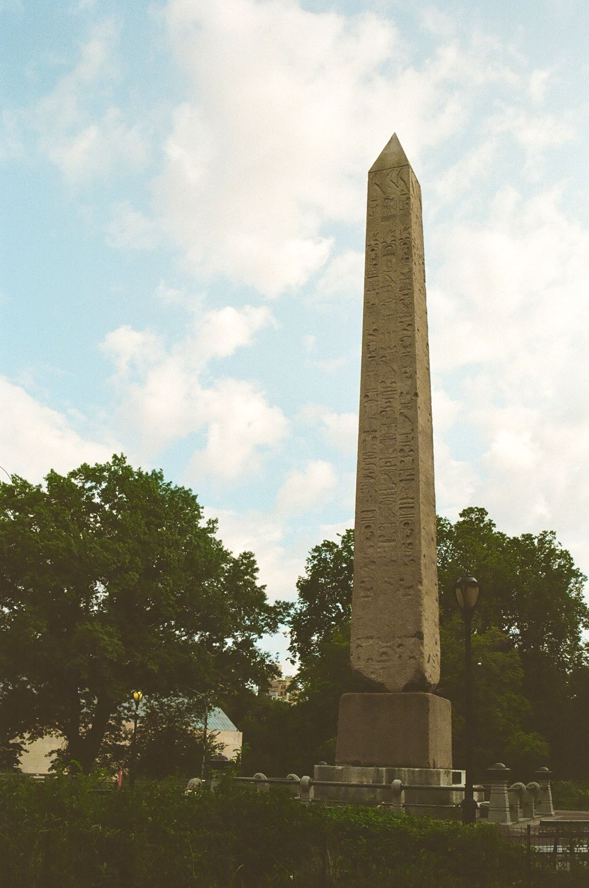 Obelisk framed by trees and sky
