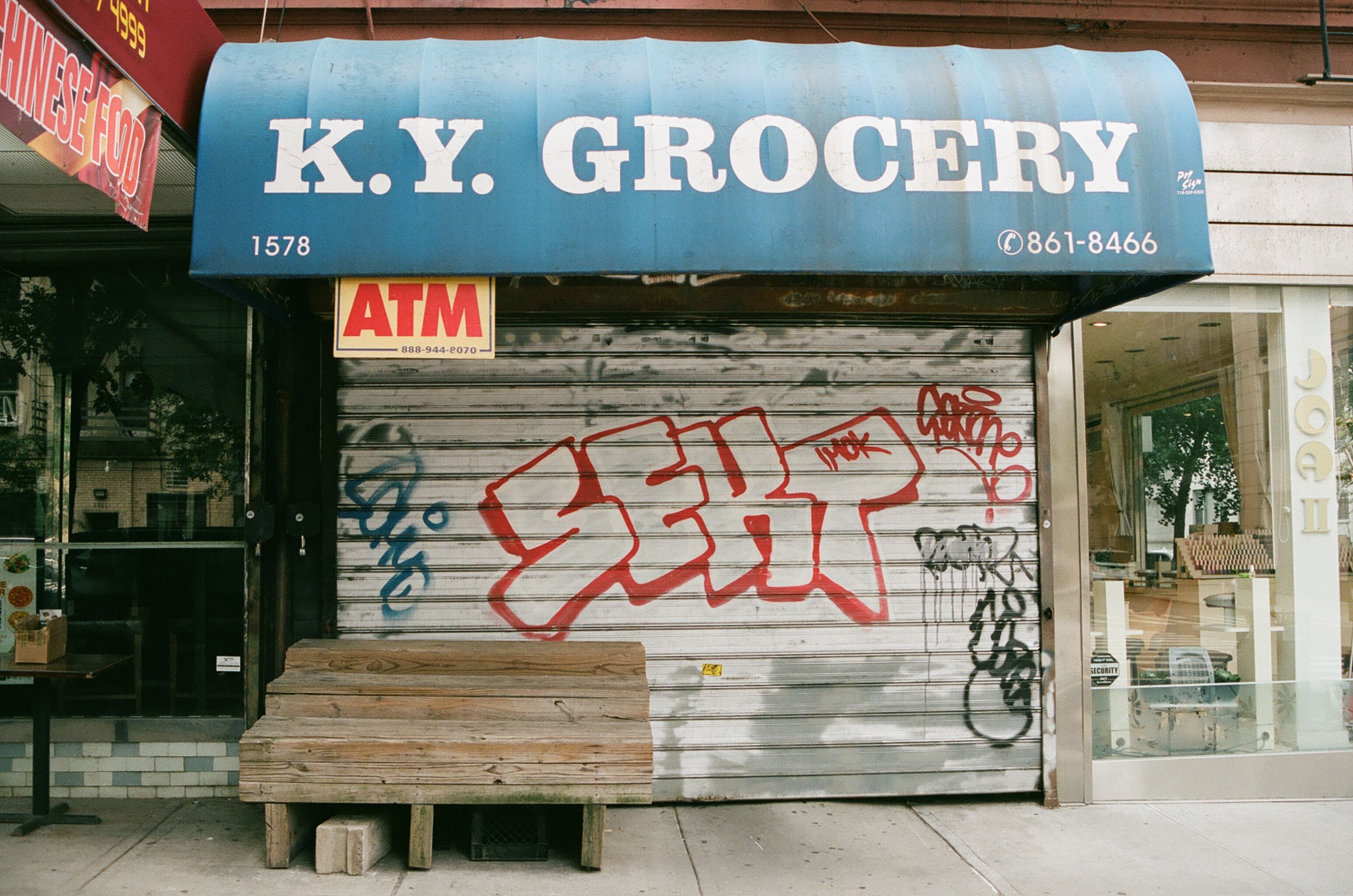 K.Y. Grocery storefront with a painted shutter