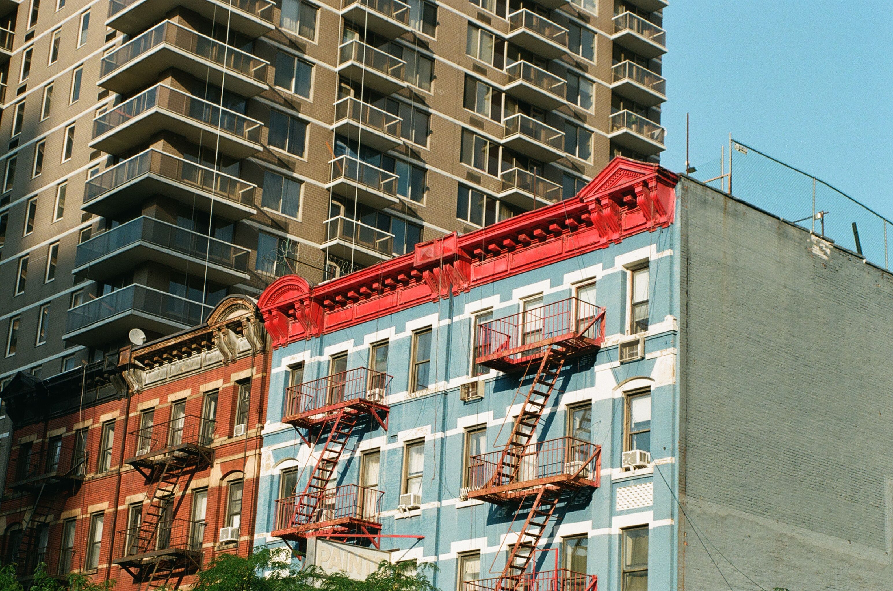 Colorful city buildings with fire escapes