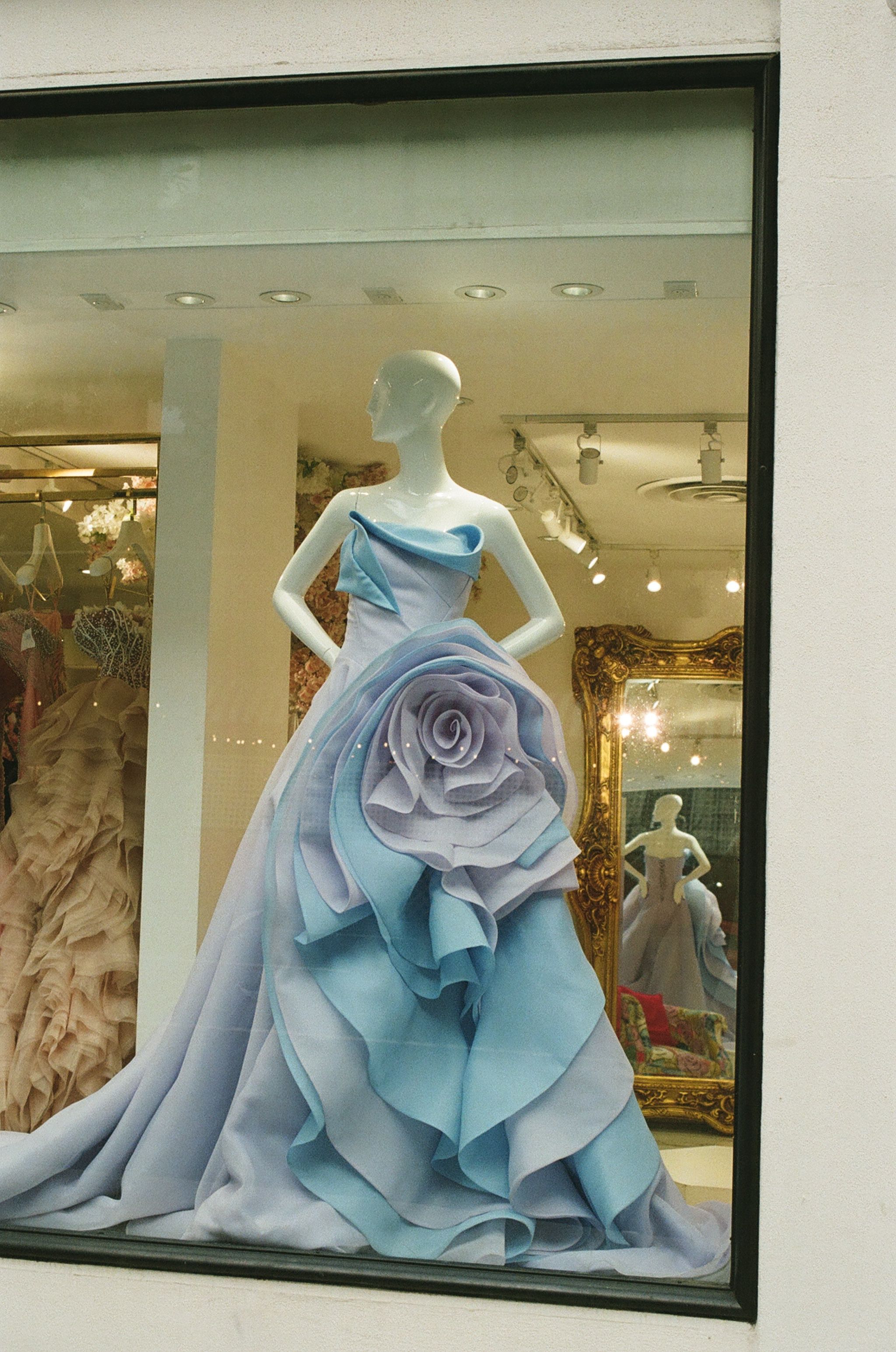 Elaborate blue dress displayed in a shop window