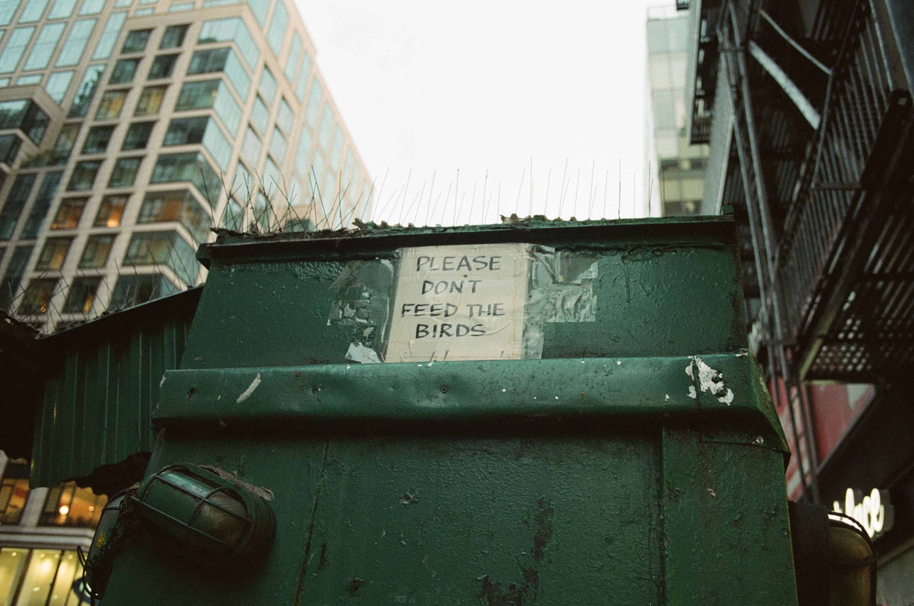 Green city structure with a handwritten notice
