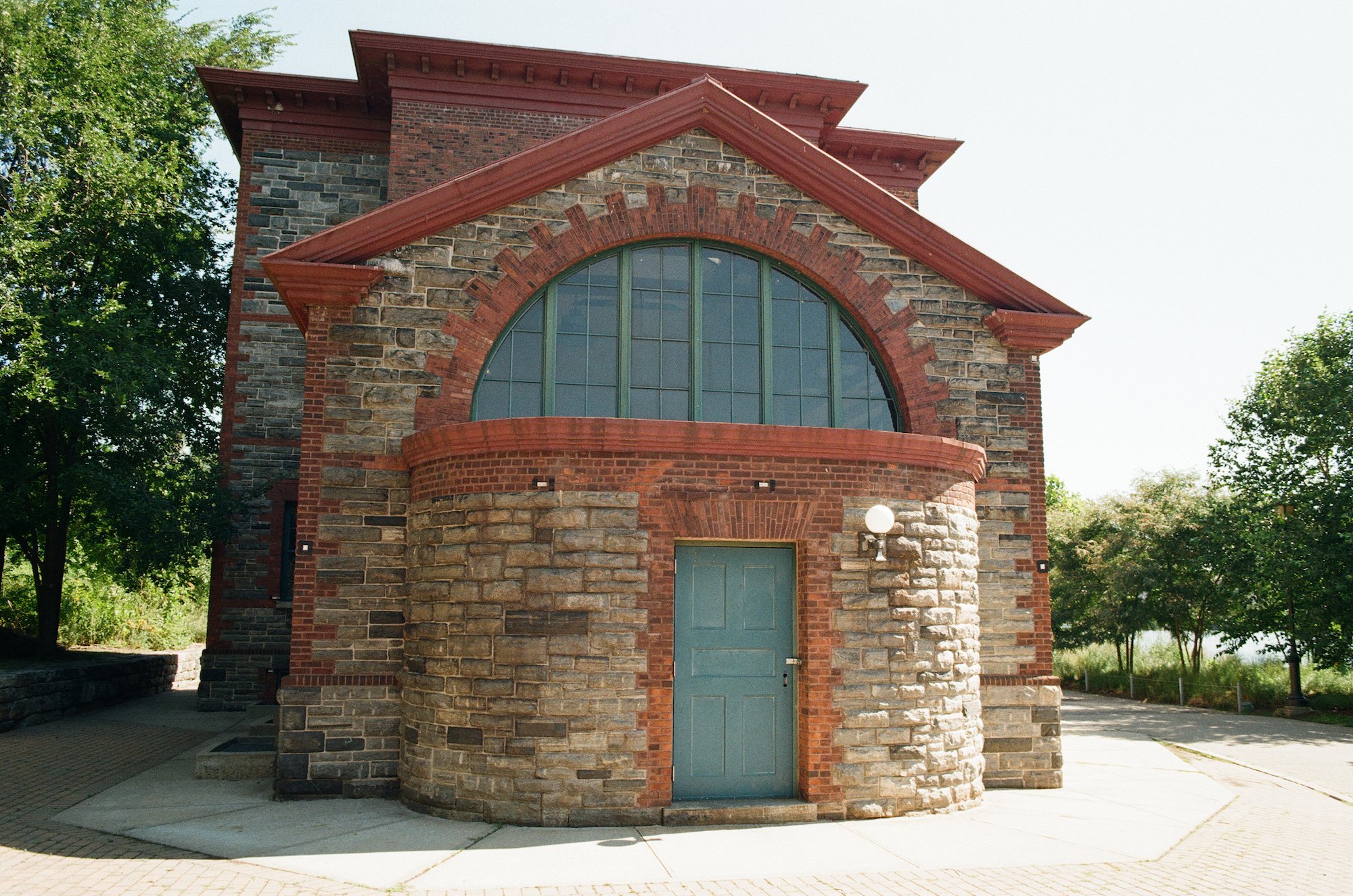 Historic stone and brick building with a green door