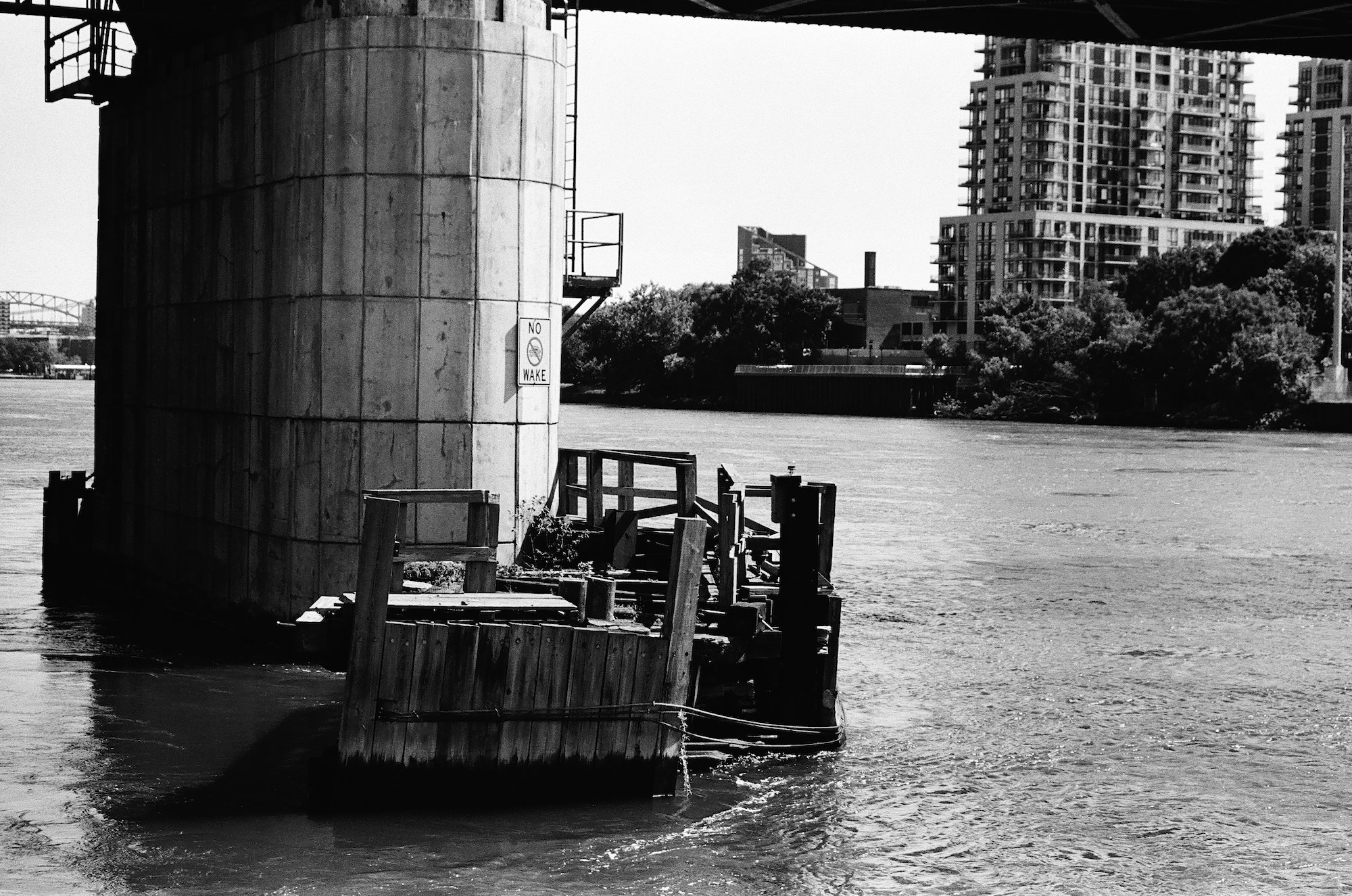 Bridge pylon and wooden landing rising from the East River